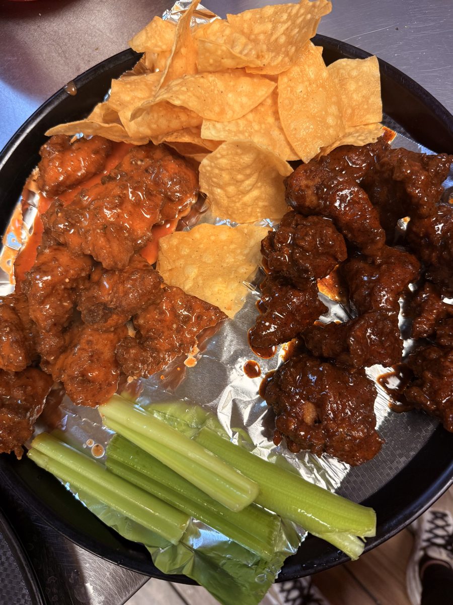 Boneless wings in buffalo and BBQ sauce with tortilla chips and celery