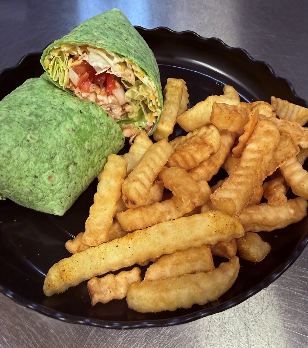 Chicken wrap in a spinach tortilla with crinkle fries